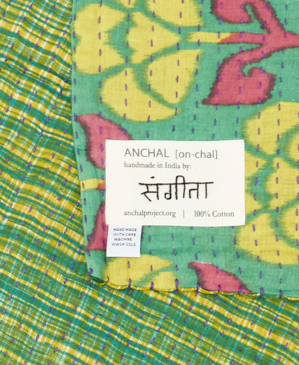 small kantha blanket with signature of the maker on the tag