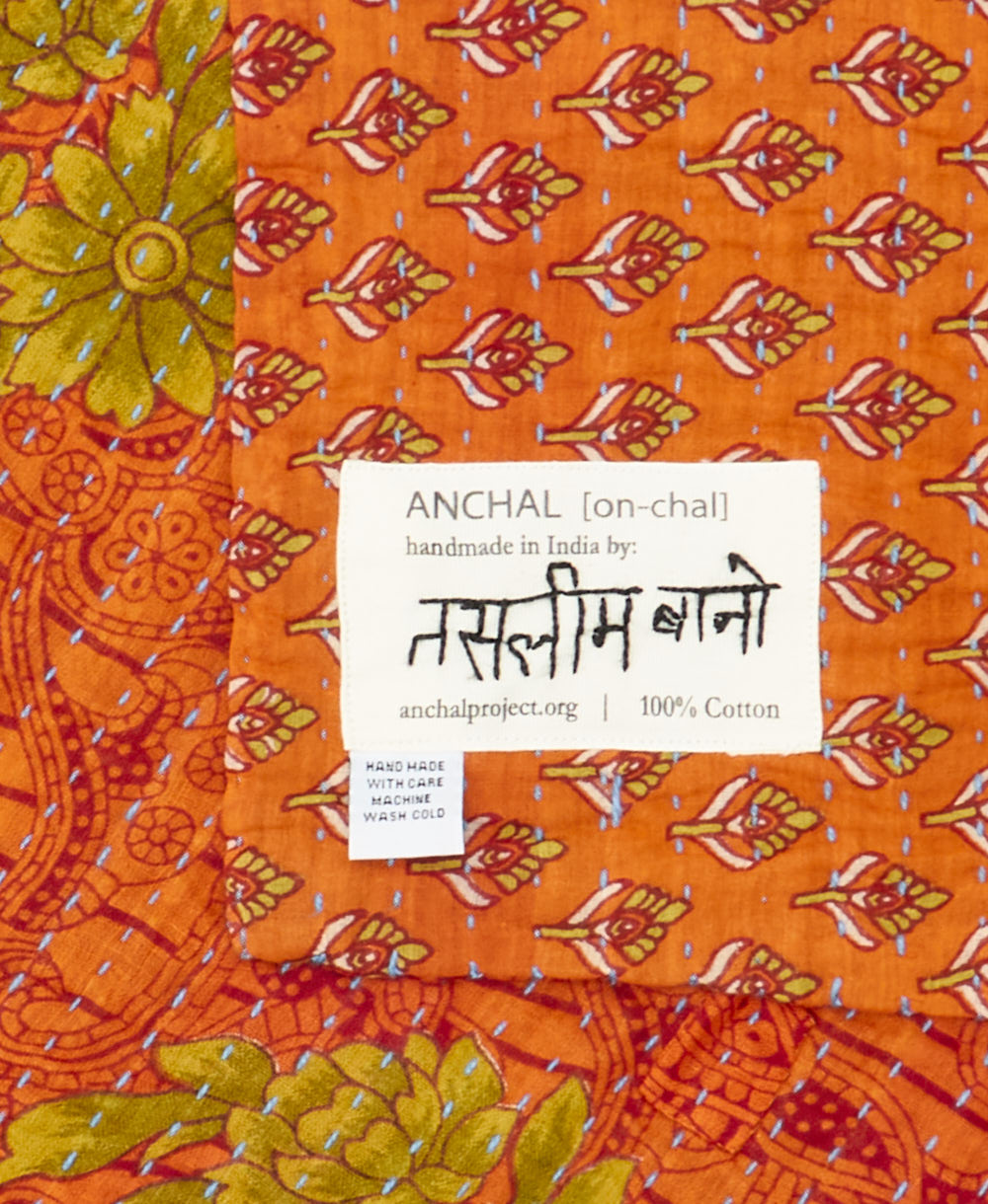 small kantha blanket with signature of the maker on the tag