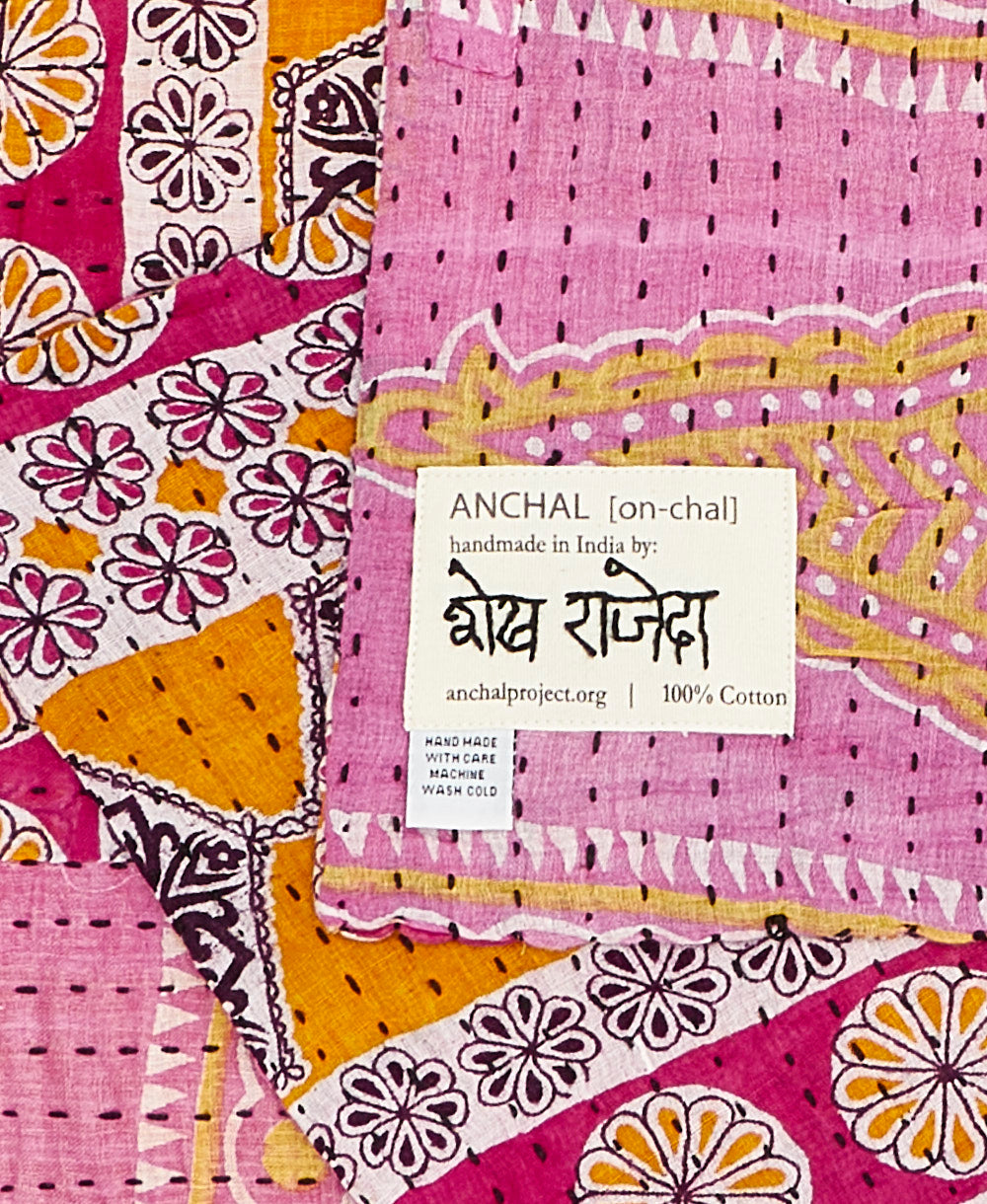 yellow and pink small Kantha quilt throw featuring the hand-stitched
signature of the maker