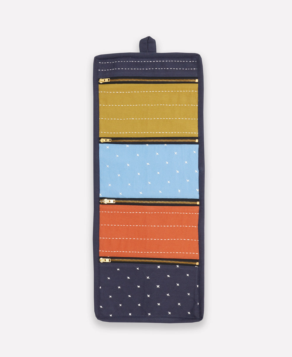 small travel organizer in shades of ochre yellow, sky blue, orange and navy blue