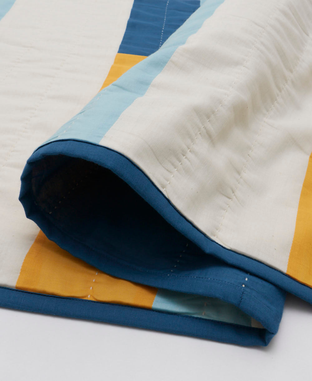 stamp patchwork quilt in white and cobalt blue