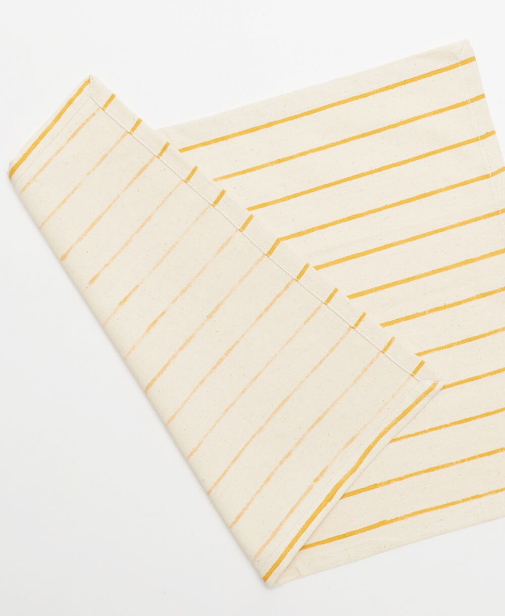 handmade striped cotton placemats in mustard yellow and natural white by Anchal Project