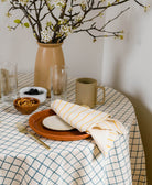 spruce green grid tablecloth with coordinating mustard yellow striped block print napkin