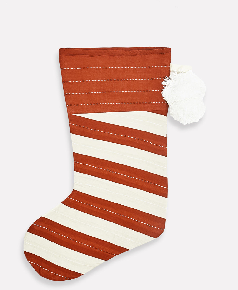 red and white striped organic cotton holiday stocking with white pom poms handmade in India