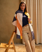 woman leaning against chair wearing quilted cocoon jacket