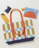 Colorful tote bag with geometric pattern with coordinating small pouches on a white background