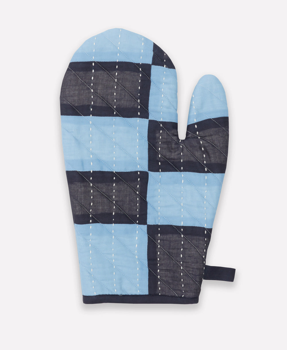 Quilted oven mitt with blue and black checkered pattern on a white background