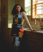 woman wearing checkered colorblock apron in kitchen