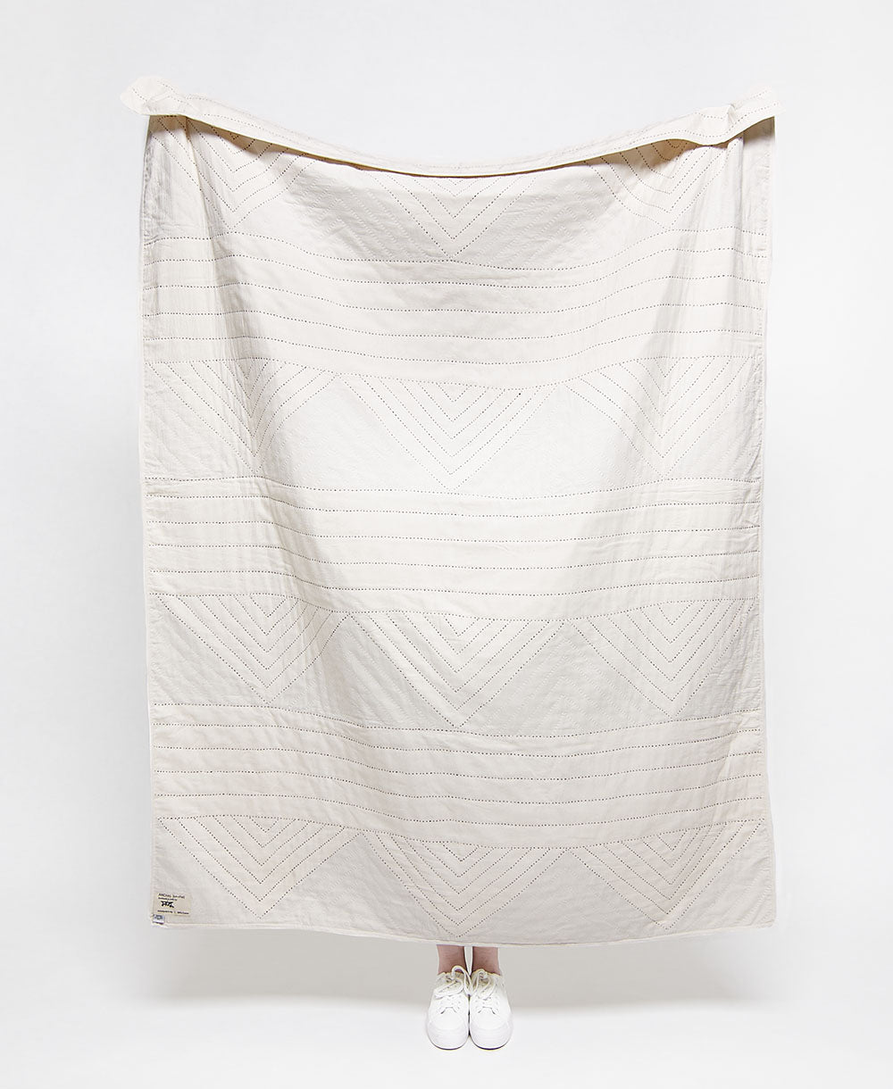 hand-stitched modern kantha quilt in triangle pattern made from 100% organic cotton