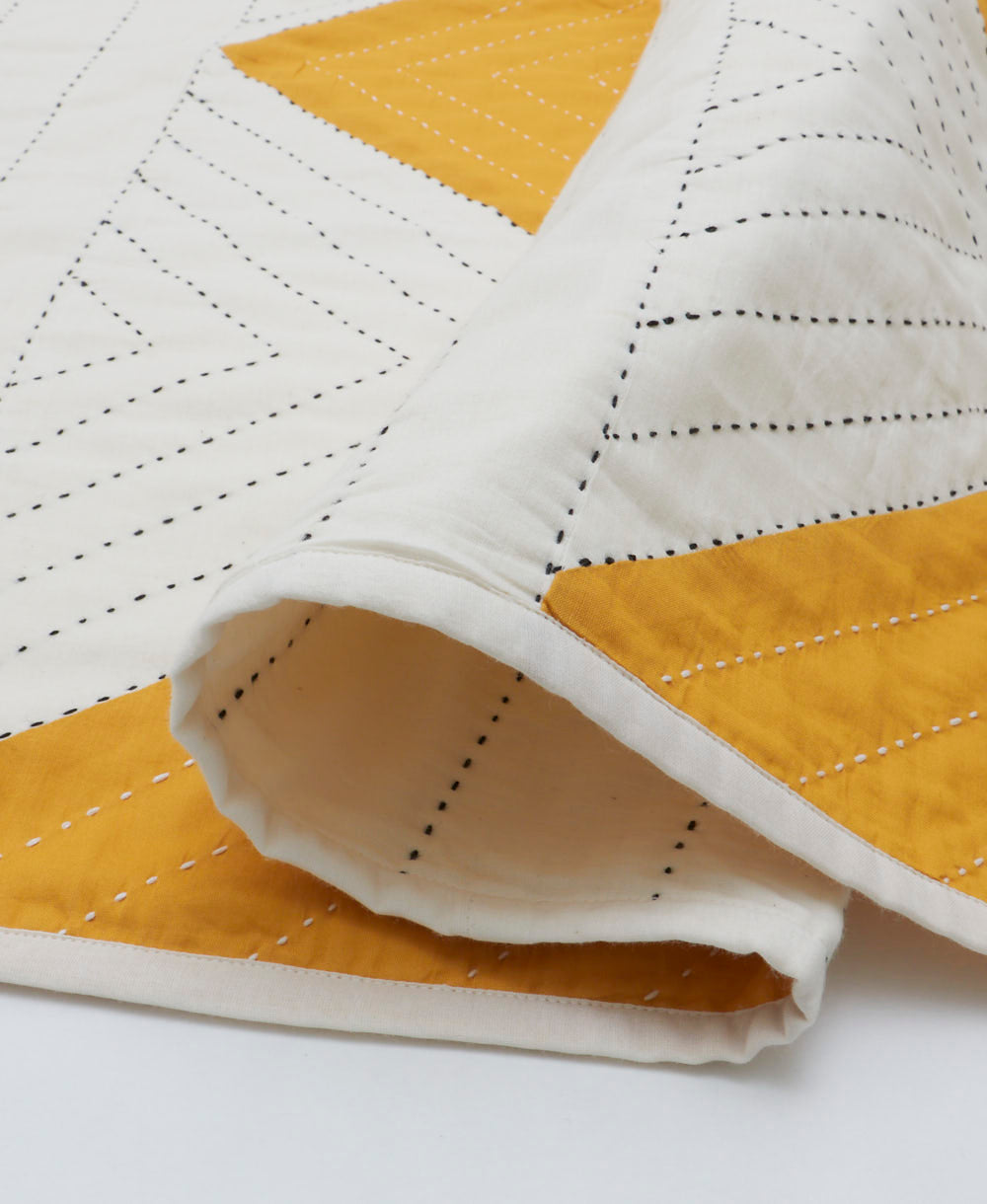 white and yellow lightweight kantha quilt with black kantha stitching