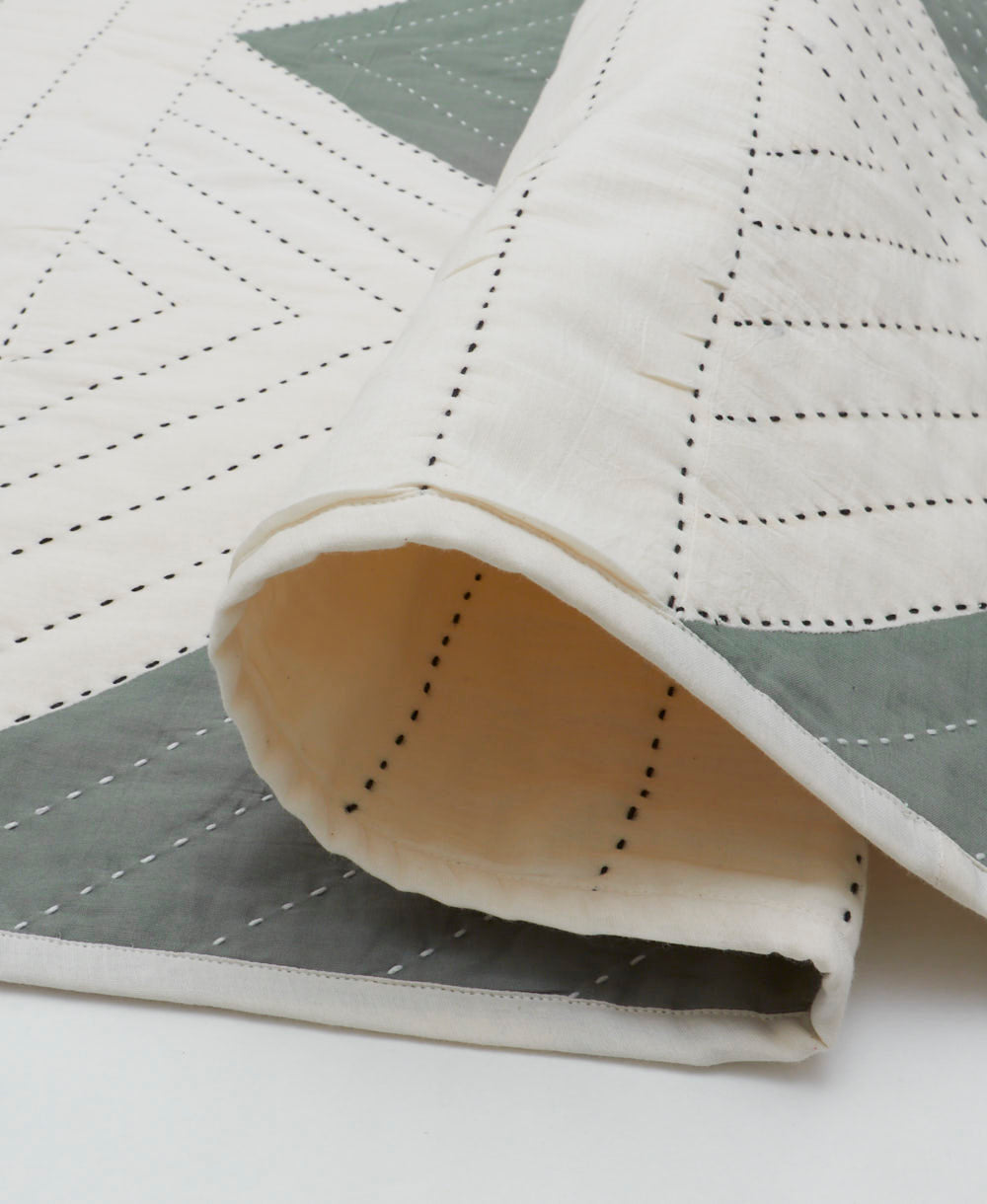 off-white lightwight modern kantha quilt with spruce green triangles and black kantha stitching
