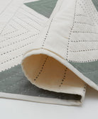 off-white lightwight modern kantha quilt with spruce green triangles and black kantha stitching