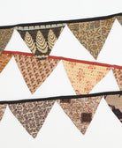 Decorative fabric bunting with various patterns on a white background