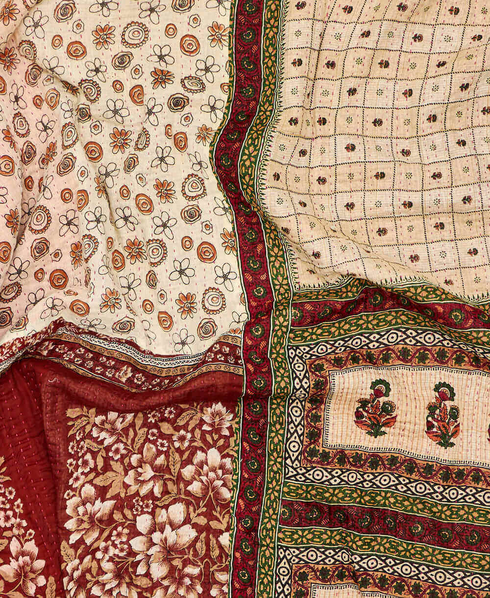 beige floral kantha quilt featuring traditional hand sitiching 