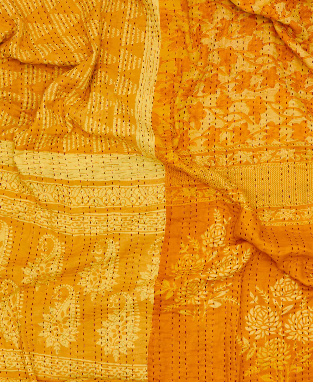 yellow floral kantha quilt featuring traditional hand sitiching 