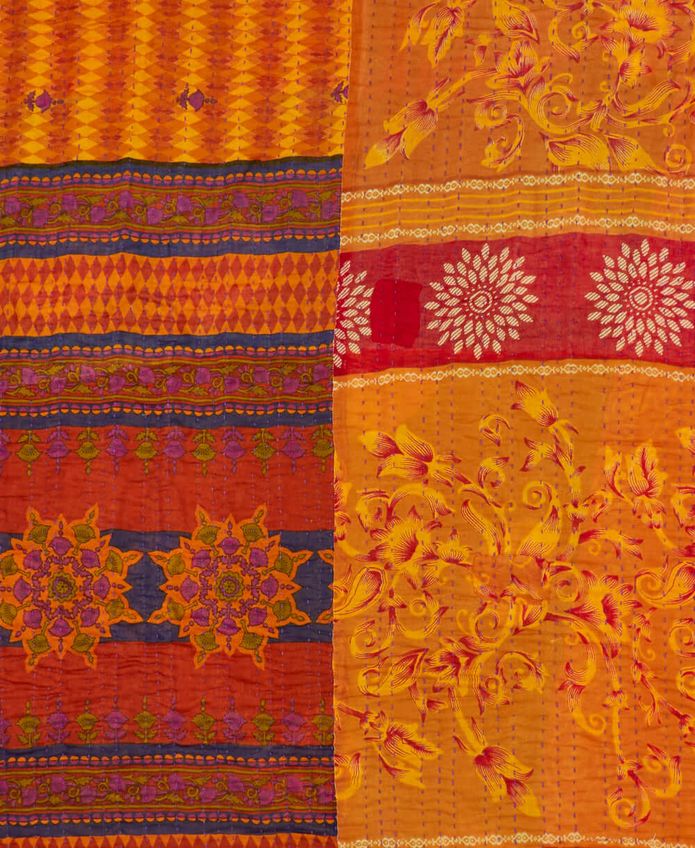 sustainable kantha quilt in twin size with an orange & red diamond pattern