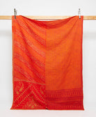 vermillion orange twin kantha quilt in a subtle floral pattern handmade in India