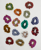 grouping of colorful vintage cotton scrunchies on white background