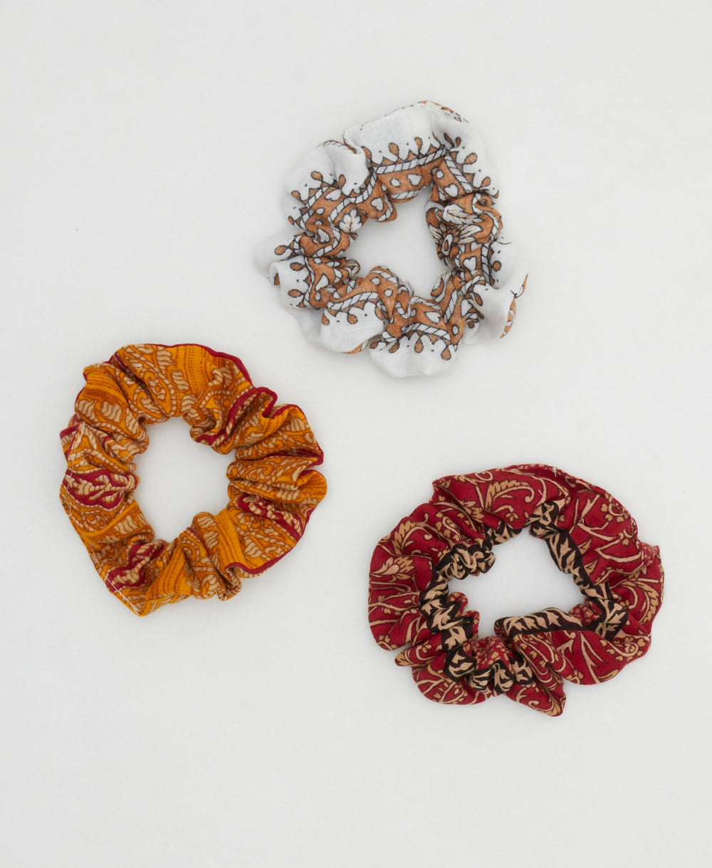 red, orange and pink vintage cotton scrunchies in unique one-of-a-kind patterns on white background