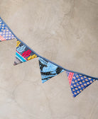 blue triangle bunting draped over a neutral wall