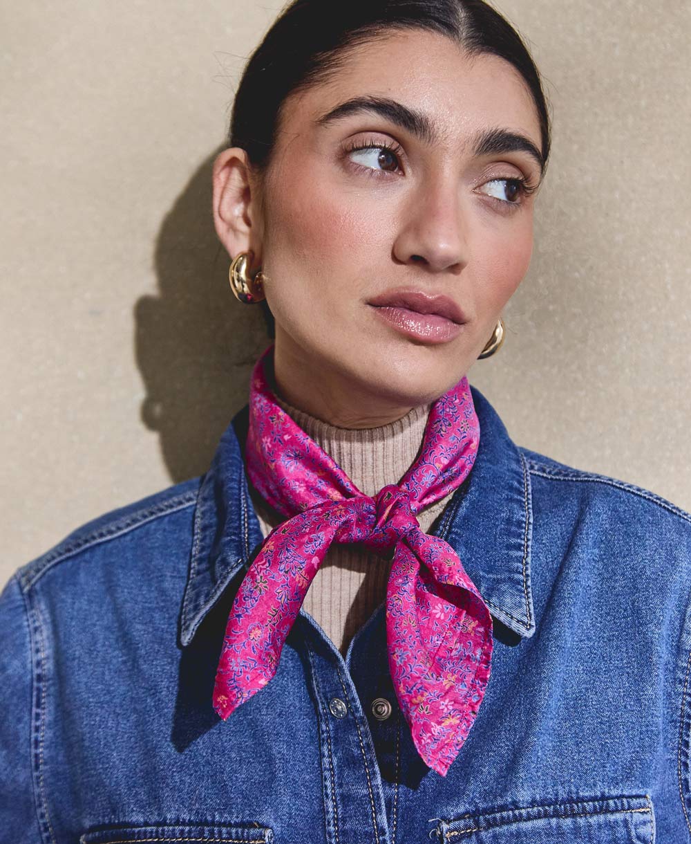 woman wearing vintage purple vintage silk bandana over layered denim jacket