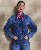 woman wearing all denim outfit with vibrant vintage silk bandana handmade in India from vintage silk saris by women artisans