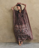 woman with dark braids wearing brown floral silk kaftan dress handcrafted in India from vintage silk saris