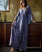 woman wearing long periwinkle silk kaftan dress by Anchal