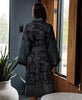 woman wearing a dark teal geometric vintage silk robe
while getting ready in her bathroom