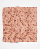 Peach silk square scarf featuring a black and brown abstract pattern