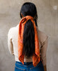 woman wearing a vintage silk scarf in her hair made from repurposed silk saris