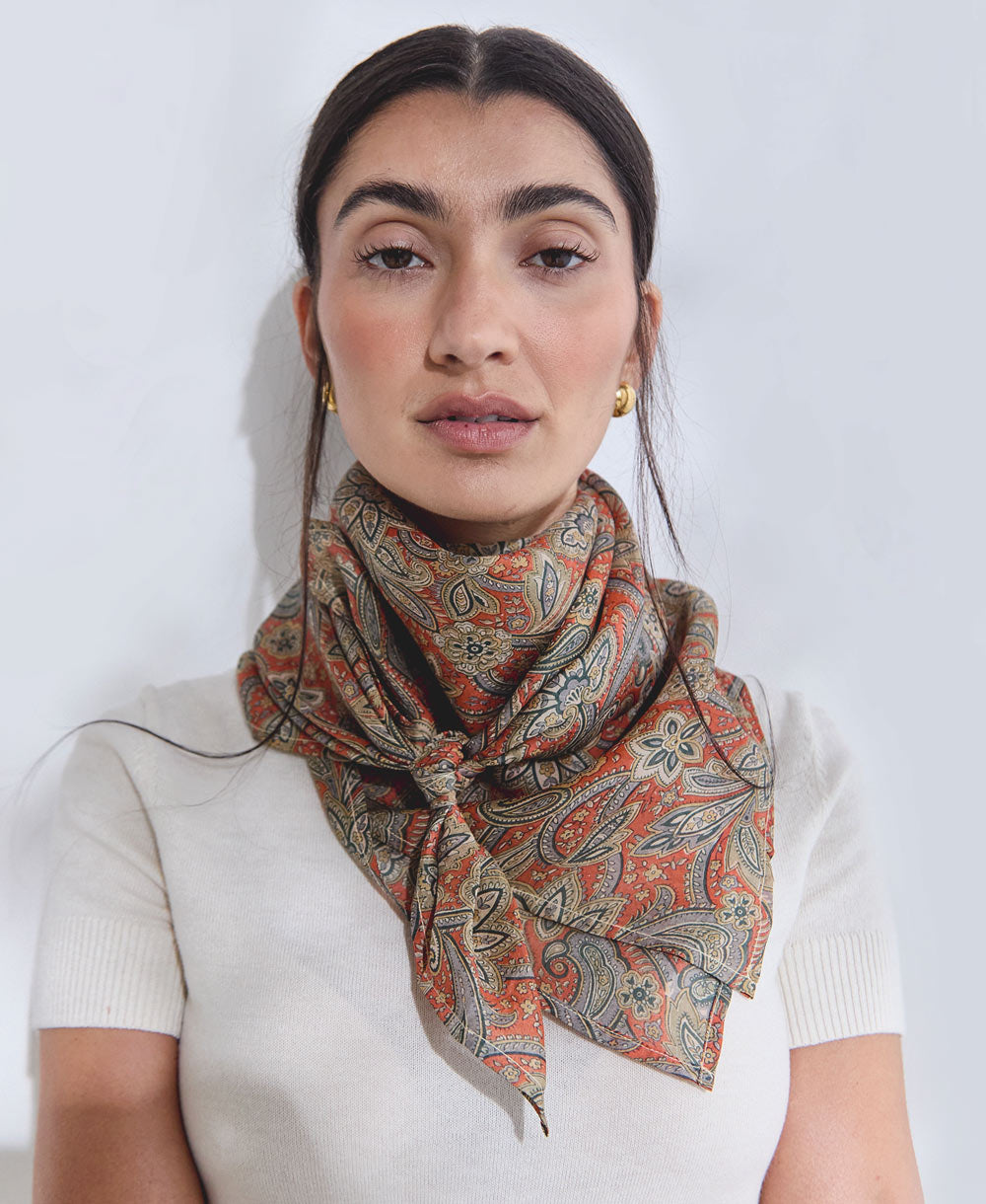 woman wearing orange and grey paisley vintage silk square scarf handmade in India from upcycled vintage silk saris