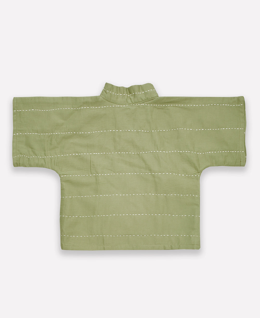 sustainable baby top in wrap style with wide bell sleeves in sage green with white horizontal embroidery