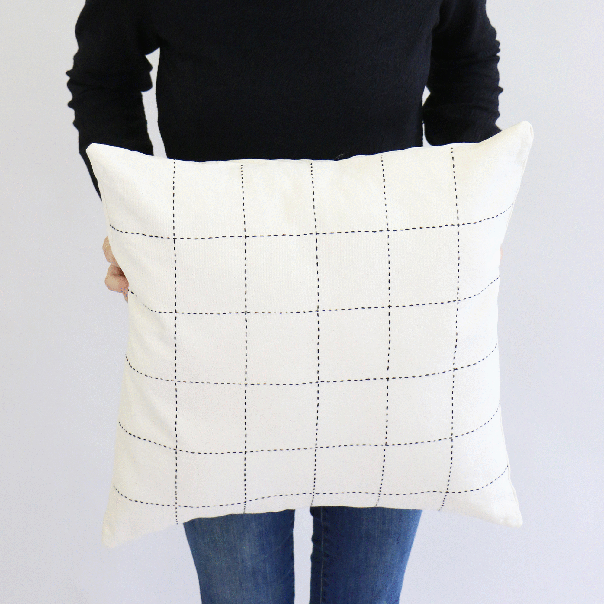 minimalist embroidered throw pillow in black and white