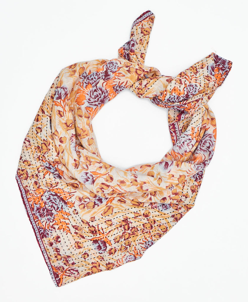 whtie cotton square scarf with yellow, orange, burgundy, and pale blue flowers and black traditional kantha stitching along the edges