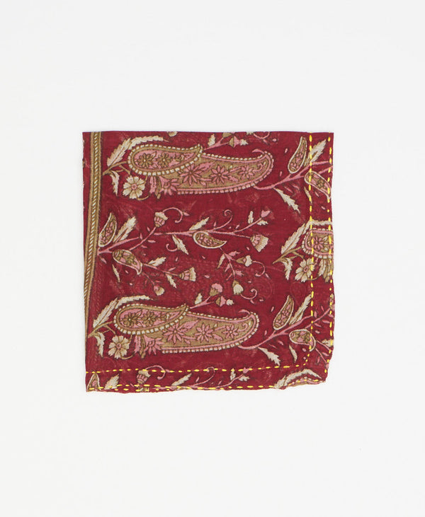 Dark red pocket square that features unique paisley patterning throughout and bright yellow Kantha stitching