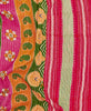 Artisan-made small quilt featuring contrasting stripes and patterns in orange, green, and pink featuring white traditional kantha hand stitching 