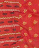 Artisan made small red throw quilt featuring contrasting patterns and blue traditional kantha hand stitching 