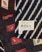 Hand stitched signature of the Artisan that created this small throw quilt 