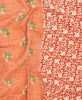 Contrasting orange floral patterns make this small throw quilt a unique one-of-a-kind piece 