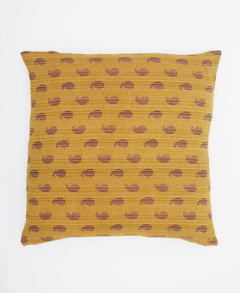 Mustard yellow pillow featuring an abstract pattern and pink traditional kantha stitching 