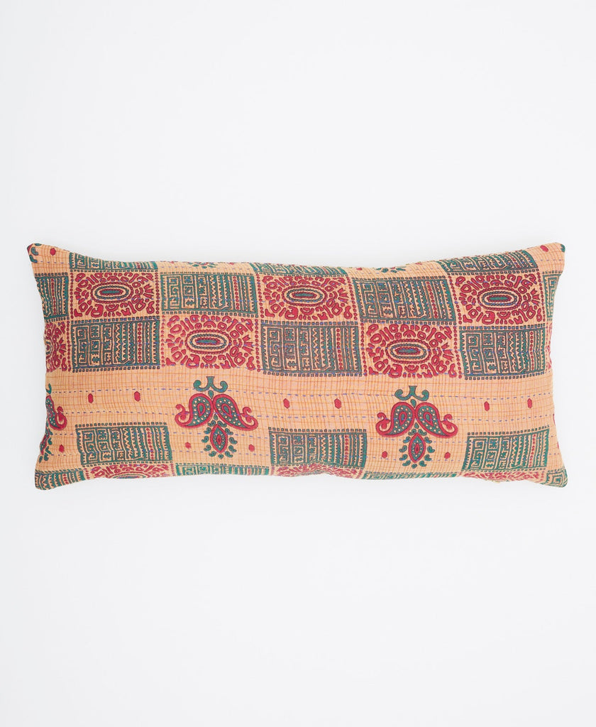 Hand made tan, green, and red lumbar pillow with an intricate pattern
