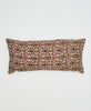beige cotton lumbar pillow with red, blue, and green floral patterns