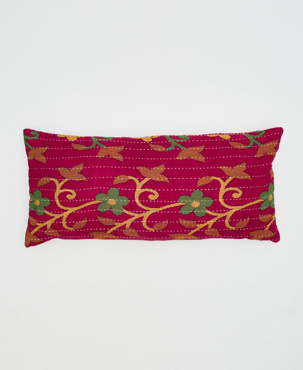 red cotton lumbar pillow with green flowers and orange and yellow vines