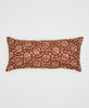 brown sustainable lumbar pillow with beige swirling vines 