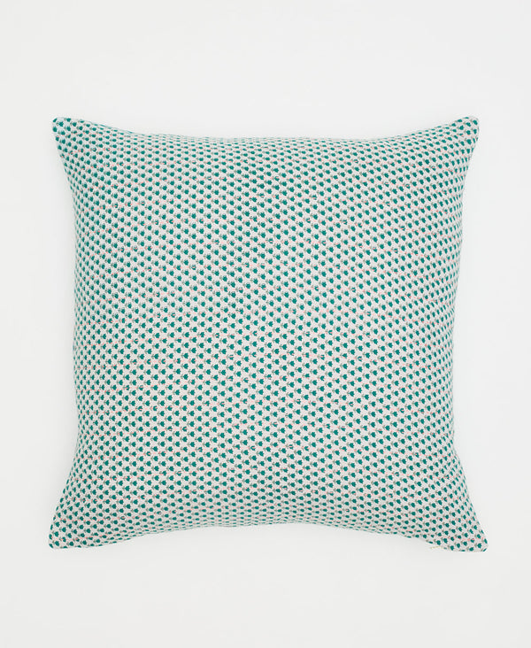 white cotton pillow with small teal flowers