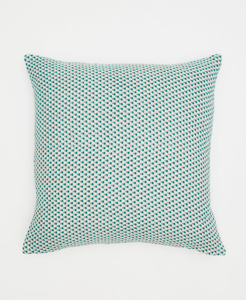white cotton pillow with small teal flowers