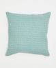 white pillow with small teal flowers 