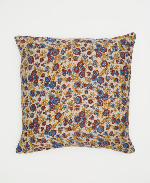 white sustainable cotton throw pillow with yellow, blue, and red flowers and traditional kantha stitching 