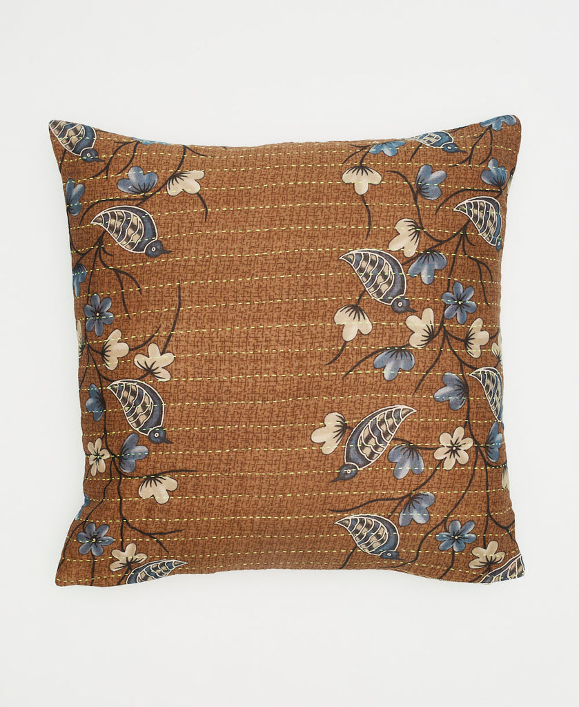 brown cotton throw pillow with blue birds and white flowers and traditional kantha stitching 